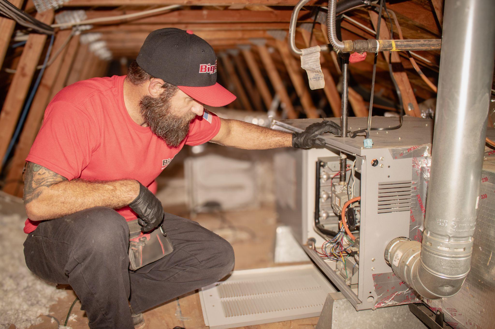 Big B's employee fixing an HVAC unit