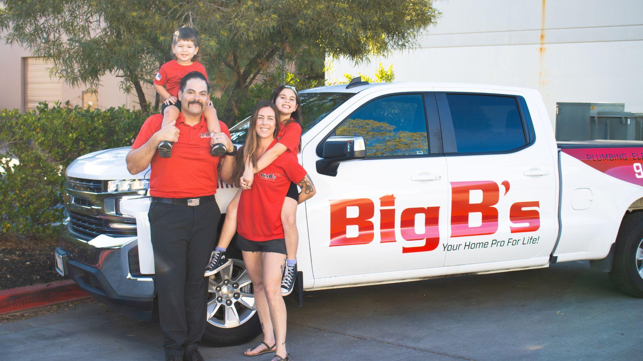 Big B's employees with children standing in front of branded truck